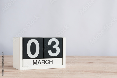 March 3rd. Day 3 of month, wooden calendar on light background. Spring time, empty space for text