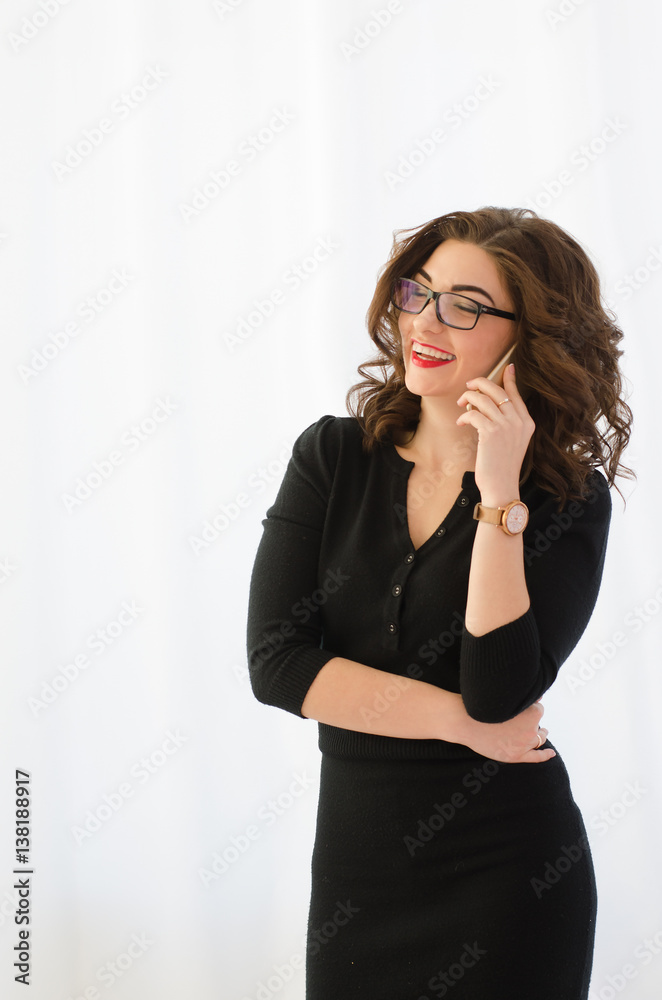 Attractive, professional businesswoman talking on the phone on a white background Attractive, professional businesswoman talking on the phone on a white background