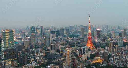 Time-lapse of Skyline with the Tokyo tower at sunset. Tokyo tower is a communications and observation tower located in the Shiba-koen district