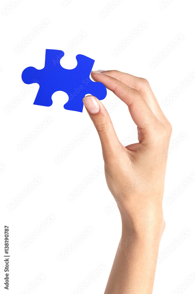 Blue puzzle in woman hand isolated on white Blue puzzle in woman hand isolated on white