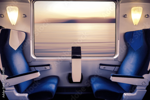 Empty seat in a train wagon overlooking the sea 