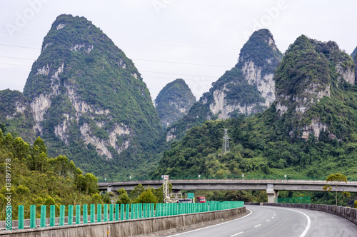 Highway road and karst mountains around in Guangxi Zhuang Autonomous Region, China