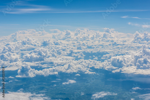 Aerial view of clouds and blue sky through airplane window, blue sky with cloud, many cloud in blue sky © bouybin