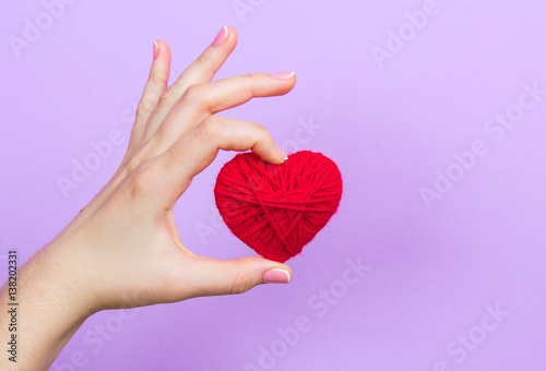 A girl holding a heart in his hands.