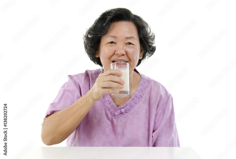 Senior adult woman drinking soy milk Senior adult woman drinking soy milk