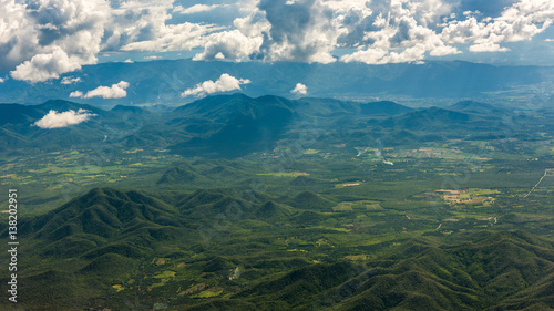 Aerial view of landscape through airplane window, landscape of the mountains, top view of mountains © bouybin