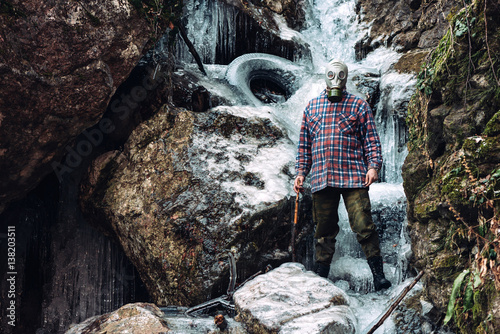 Scary man in the frozen waterfall