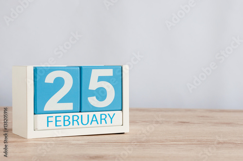 February 25th. Day 25 of month, calendar on wooden table background. Winter concept. Empty space for text