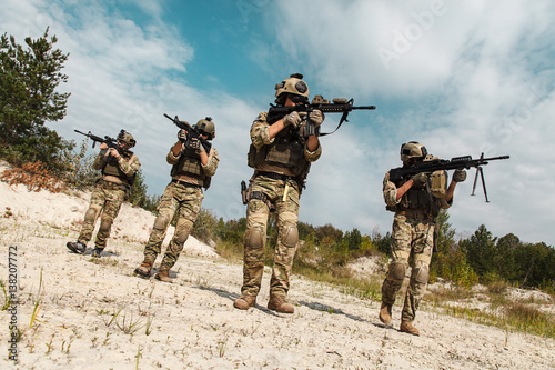 Fireteam of US Army Rangers in the desert moving towards the camera photo
