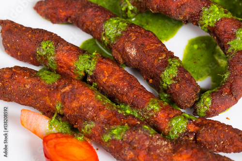 Chicken fingers - a spicy Indian dish served with green coriander chutney