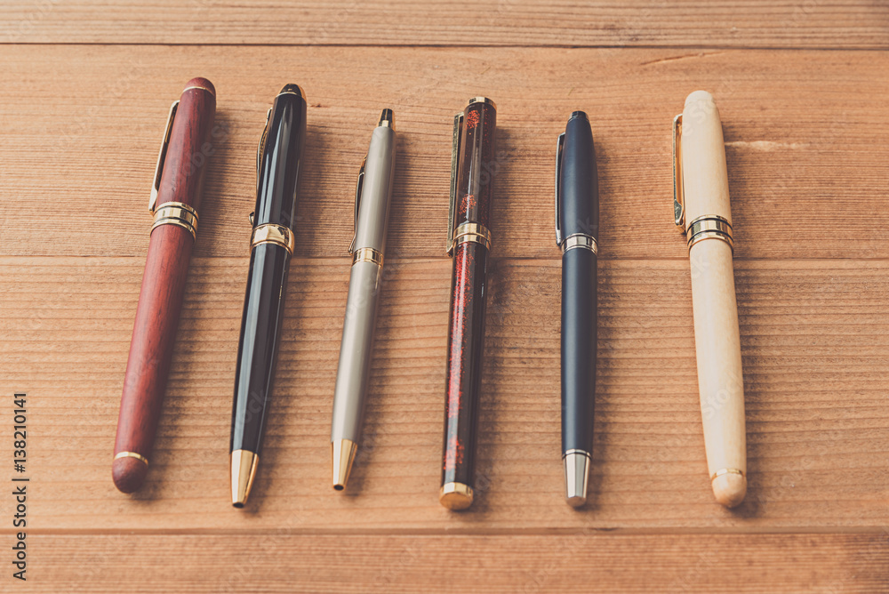 many pen on wood table