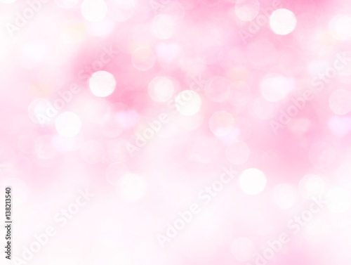 Light pink blurred background.