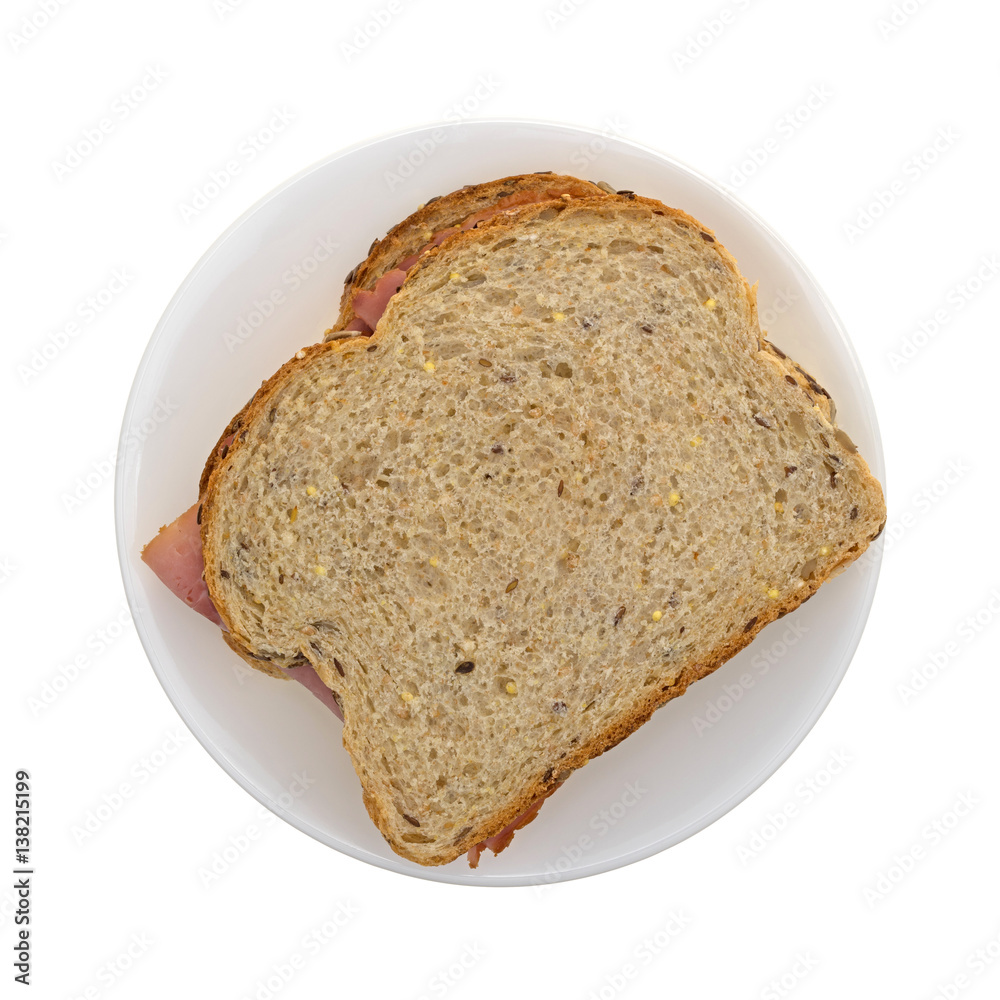 Top view of an applewood smoked ham sandwich on a plate isolated on a white background.