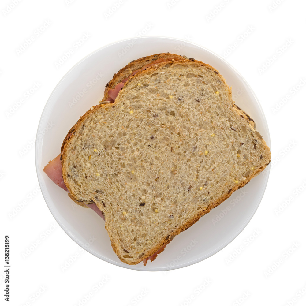 Top view of an applewood smoked ham sandwich on a plate isolated on a white background. Top view of an applewood smoked ham sandwich on a plate isolated on a white background.