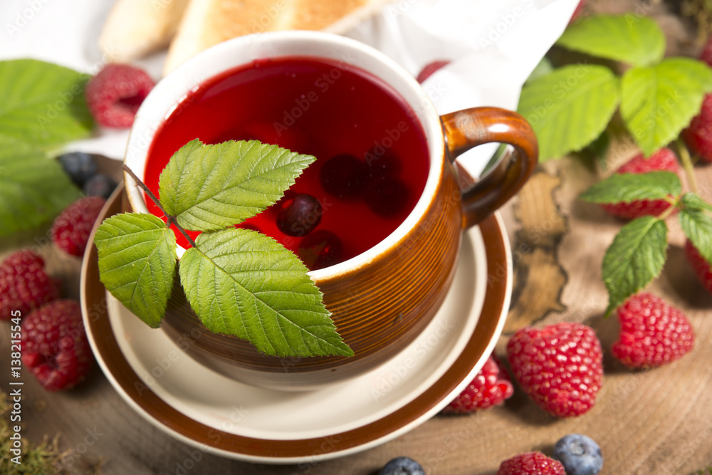 raspberry tea on a stump in the forest mushrooms and berries raspberry tea on a stump in the forest mushrooms and berries