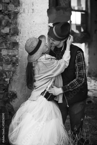 Love happy couple on a date on the ruins of an old building with a guitar