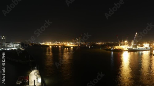 view from the elbphilharmonie in Hamburg with ships passing by and container ships being loaded and unloaded in Hamburg, Germany 2017