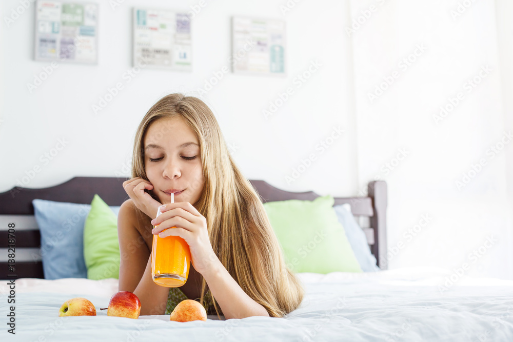 Girl drinking juice and relaxing in bedroom Girl drinking juice and relaxing in bedroom