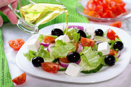 Fresh greek salad on white table