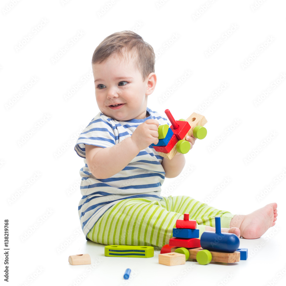 Baby boy playing with blocks toys looking away in surprise. Isolated on white. Baby boy playing with blocks toys looking away in surprise. Isolated on white.