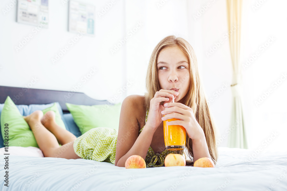 Girl drinking juice and relaxing in bedroom Girl drinking juice and relaxing in bedroom