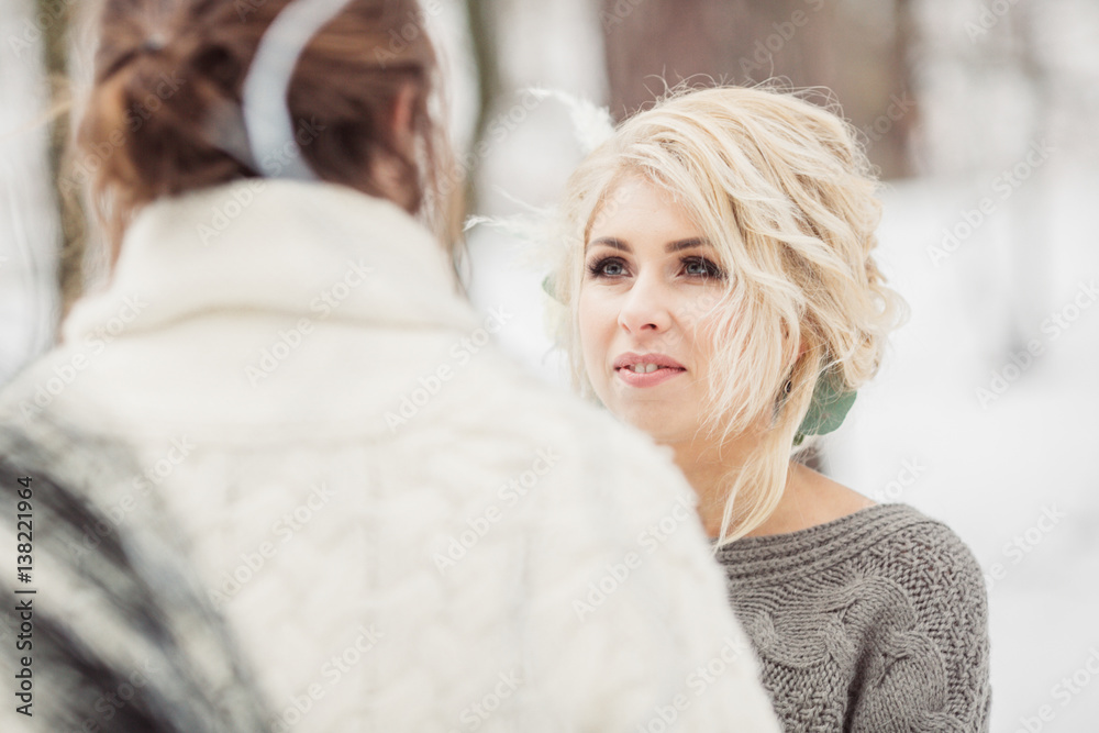 Happy stylish couple in the winter park outside
