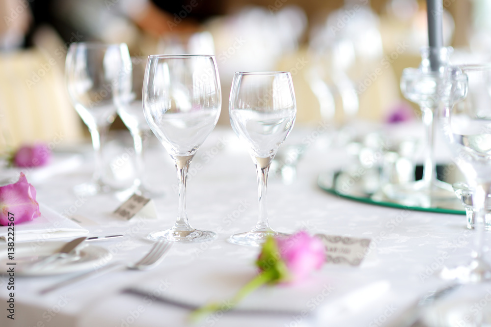 Beautiful table setting with crockery and flowers for a party, wedding reception or other festive event Beautiful table setting with crockery and flowers for a party, wedding reception or other festive event