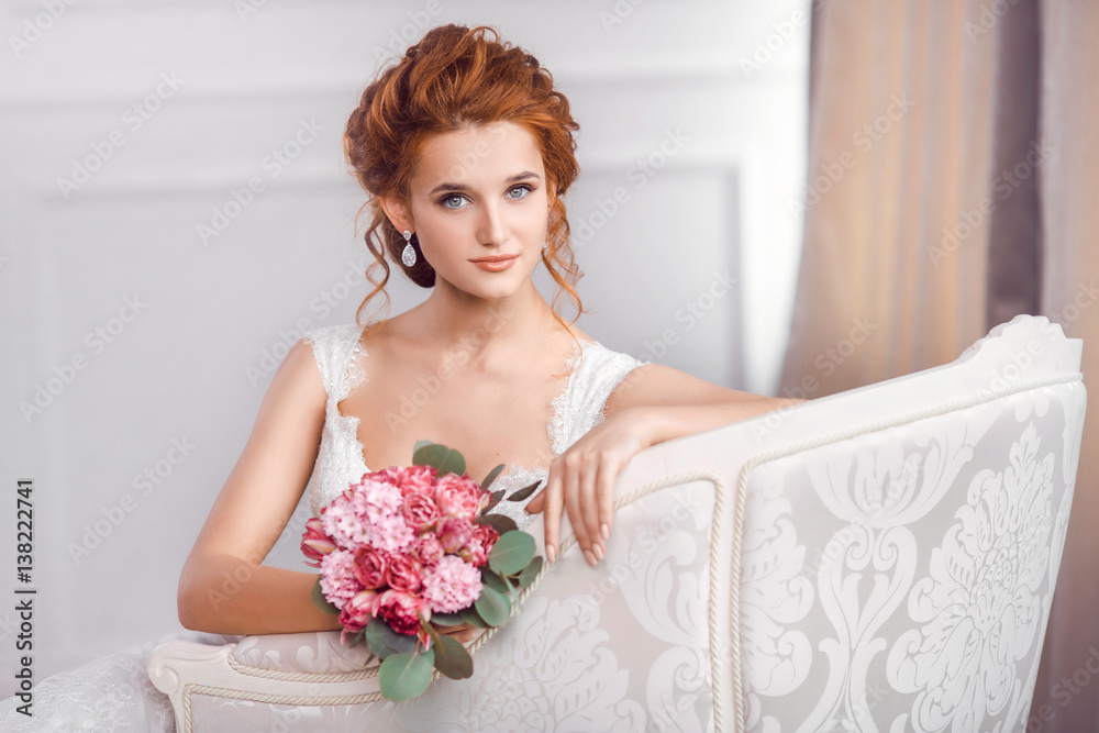 Bride in beautiful dress sitting resting on sofa indoors Bride in beautiful dress sitting resting on sofa indoors