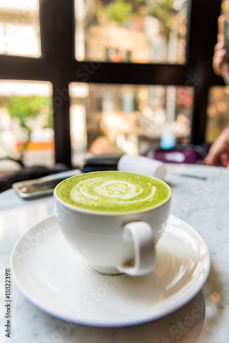 Hot green tea matcha latte in a cup