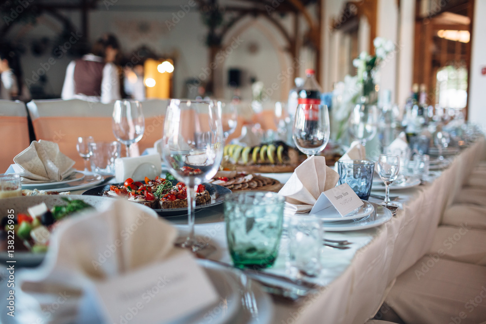 The dishes,bottles and plates stand on the table The dishes,bottles and plates stand on the table