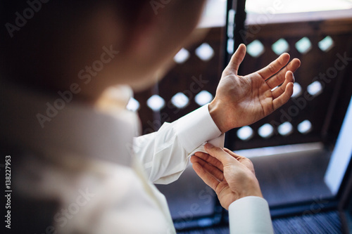 The groom wears a shirt