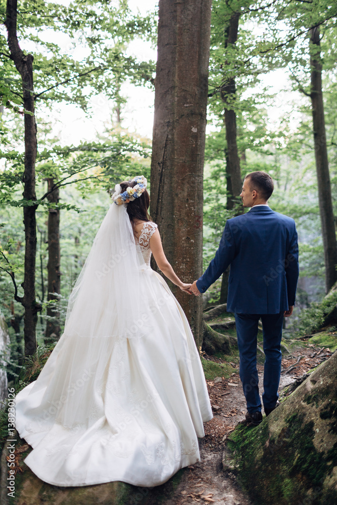 The brides walking along forest