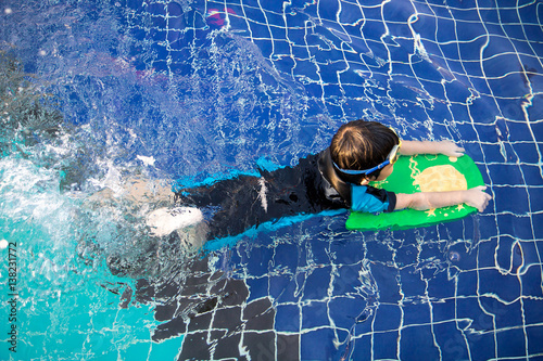 boy learn to swim in the swimming pool