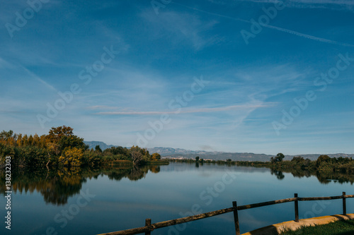 relaxing lake ELBA in spain with a view on the woods from a terrace. Blue Sky with some white clouds