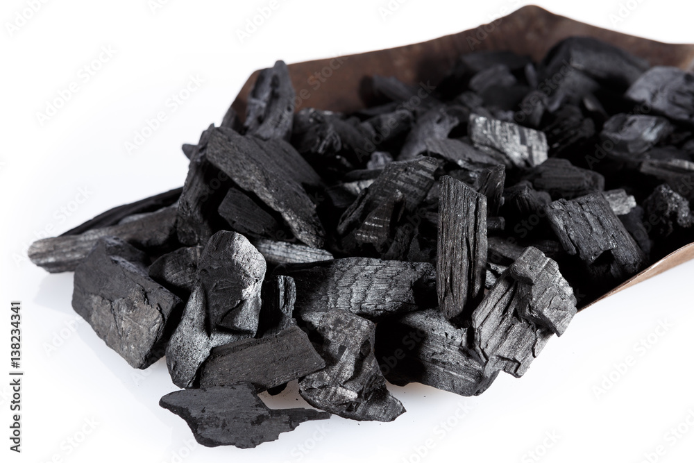 Pile of charcoal and shovel isolated on white