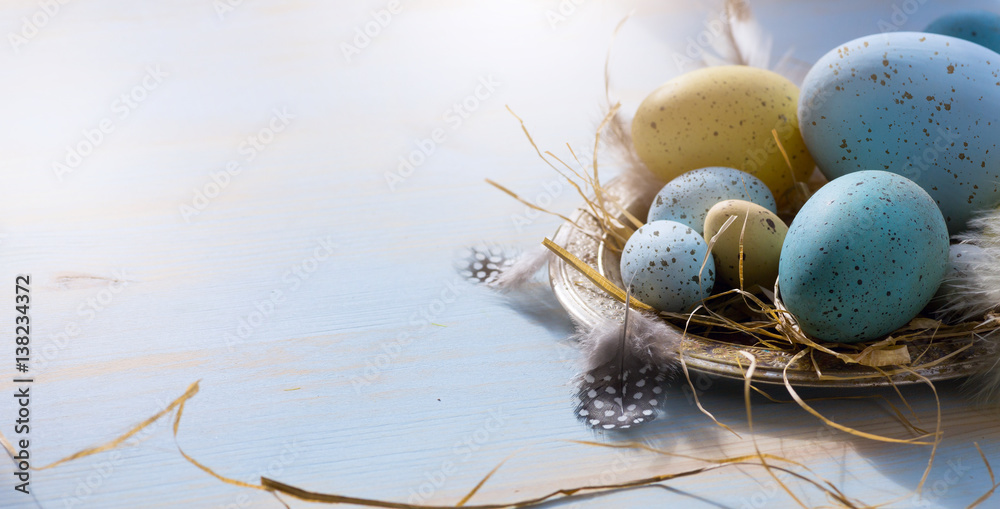 Fototapeta Happy Easter; Easter eggs on blue table background. Holidays view with copy space