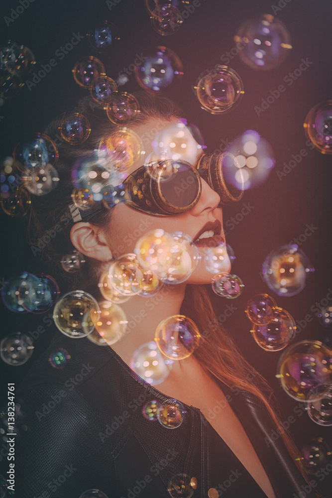 Double exposure of beautiful steampunk woman portrait and soap bubbles