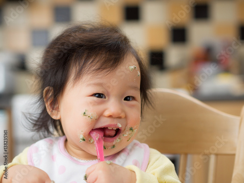 baby eating messy mashed potato