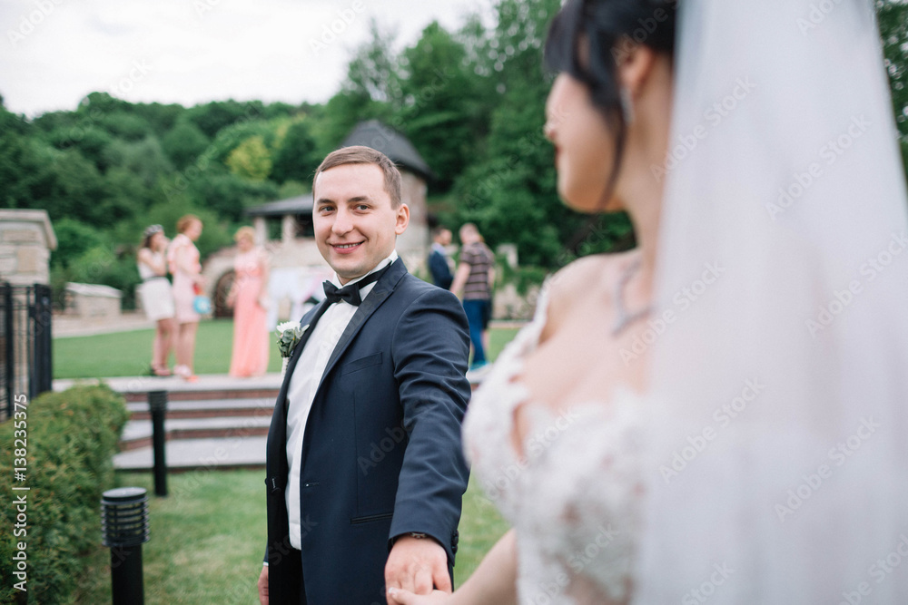 beautiful and young bride and groom standing outdoors beautiful and young bride and groom standing outdoors