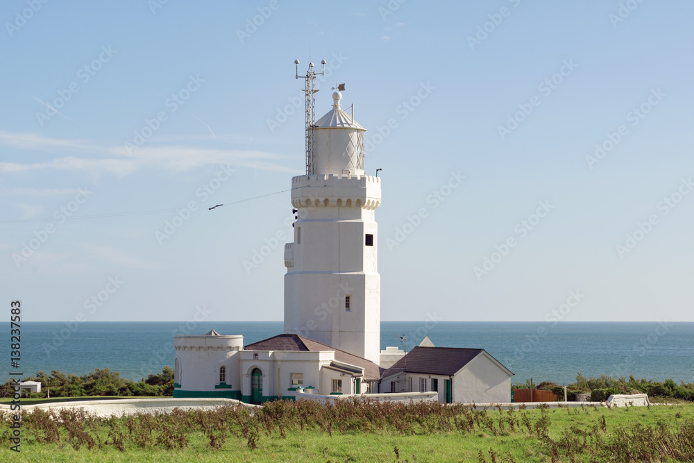 A lighthouse off the Isle of Wight coastline on a warm summer's day