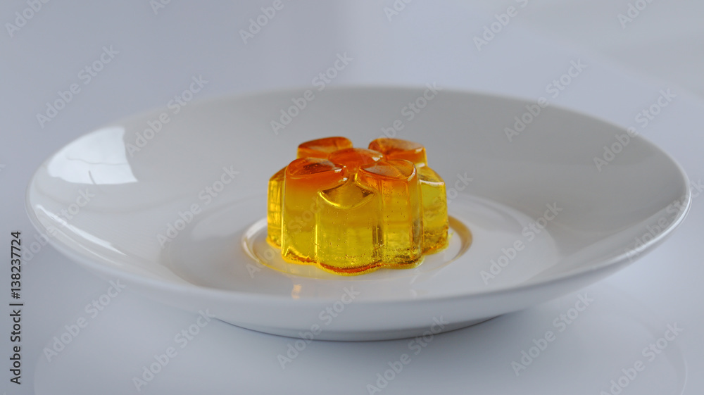 One  lemon jelly on a white plate 