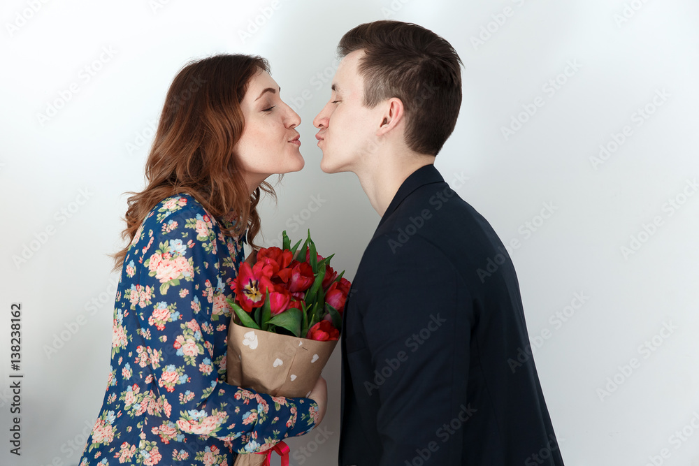 Love couple kissing, woman with tulip bouquet Love couple kissing, woman with tulip bouquet