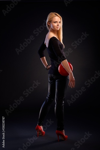 Pretty girl in black with red ball