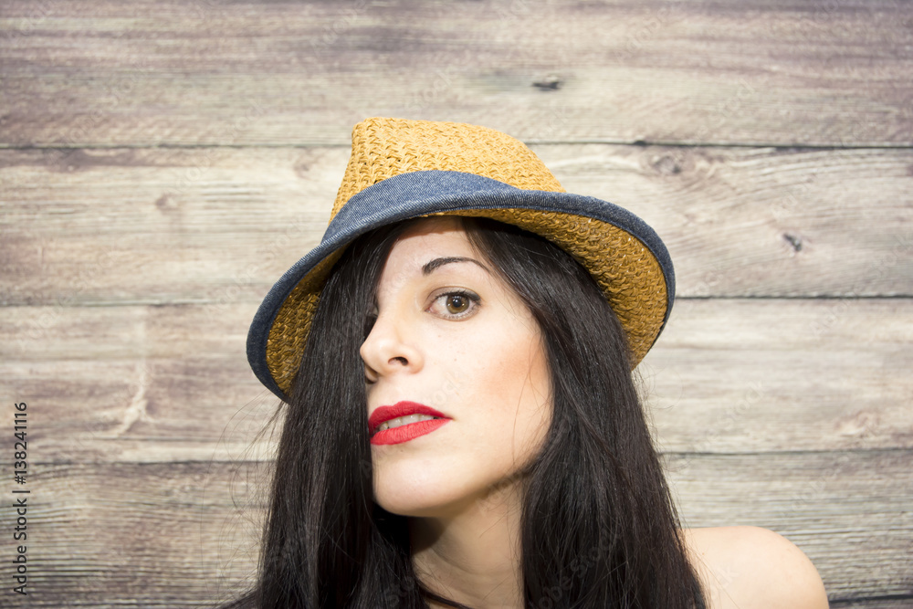 Beauty Woman with hat on a wooden background Beauty Woman with hat on a wooden background