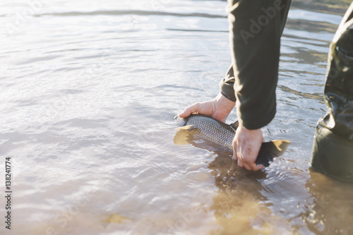 Man letting go to the fish photo