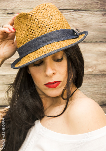 Beauty Woman with hat on a wooden background