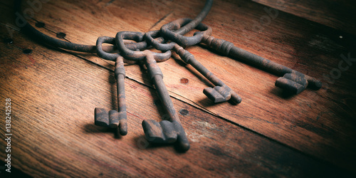 Slika na platnu Old keys bunch on a wooden background. 3d illustration