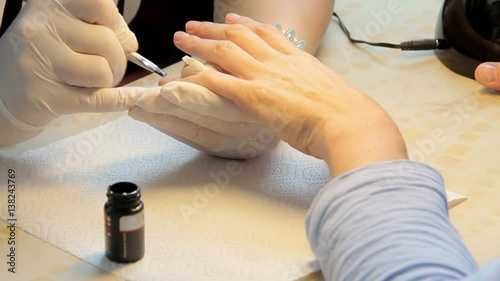 Nail Technician Giving Customer a Manicure photo