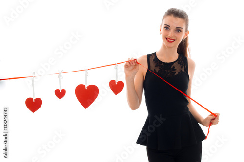 happy brunette woman in love posing with red heart on background isolated on white background