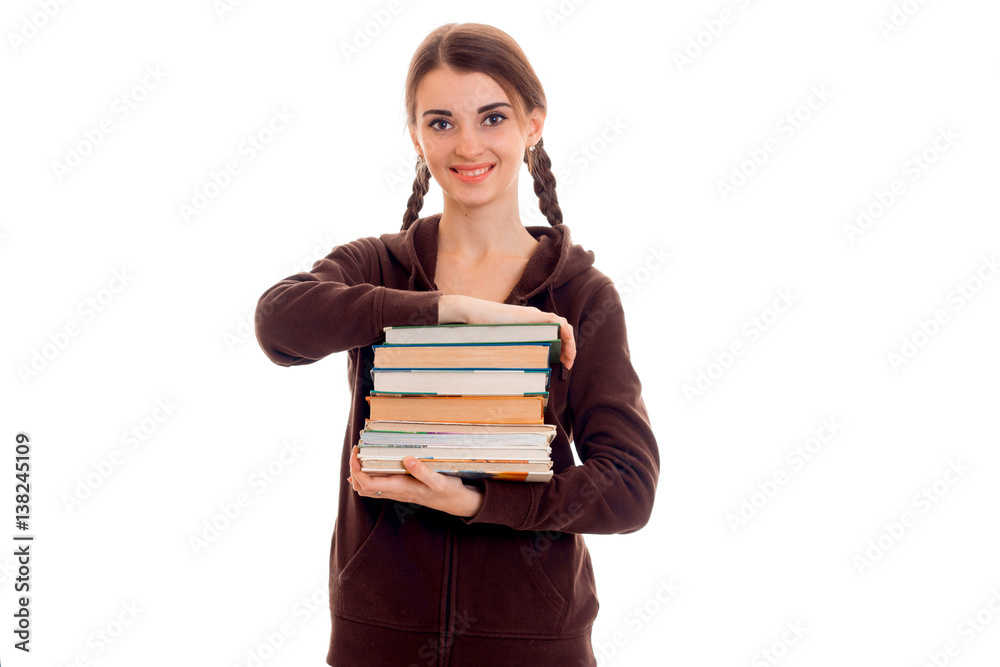 cutie stylish student girl with pigtails in brown sports clothes and books in her hands smiling isolated on white background cutie stylish student girl with pigtails in brown sports clothes and books in her hands smiling isolated on white background